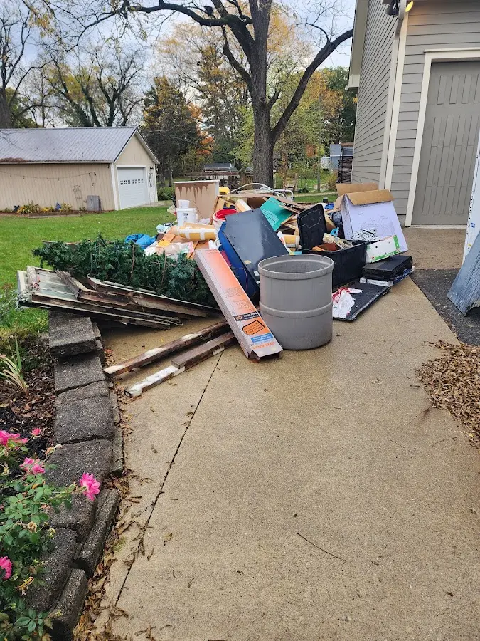 Dumpster being loaded with debris for Estate Cleanout Dumpster Rental in South Salt Lake